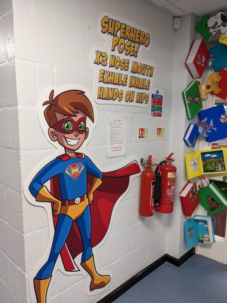 Superhero-themed sensory pathway wall sticker in a school hallway, designed to engage and stimulate children's movement and coordination.