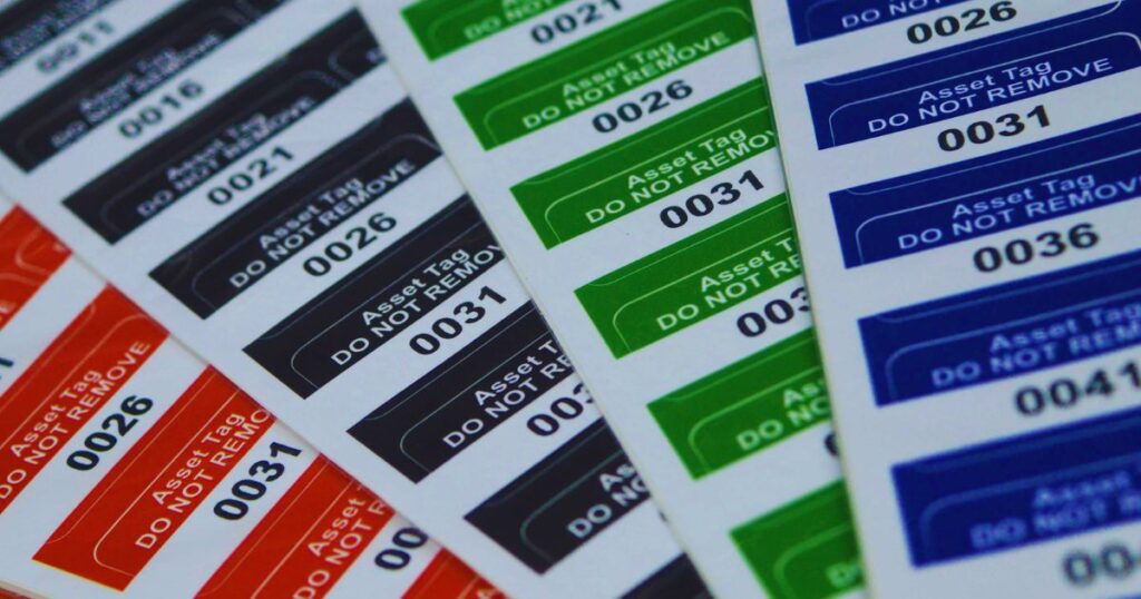 Close up of multiple sheets with coloured labels on them