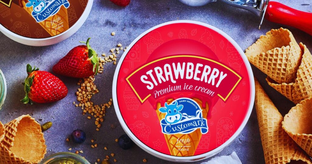 An overhead view of a lid with a red label on it. The label says strawberry and has a photo of an ice-cream cone.